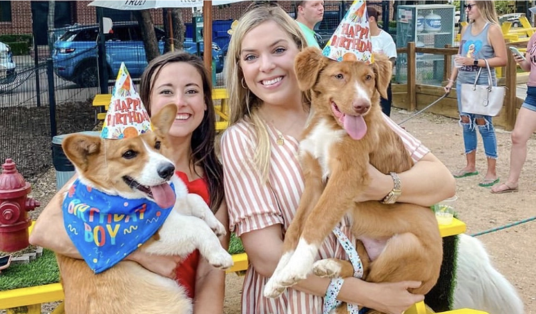 Pet owners celebrating pet birthday at Mutts Canine Cantina